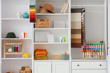 Closet with tailor's supplies in atelier
