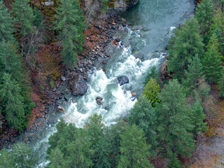 Aerial View Of Turquoise River Surging Through Dense BC Forests In Canada