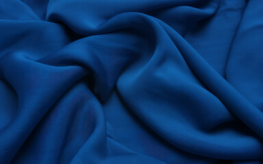 Obraz premium Closeup of luxurious royal blue silk fabric with elegant drapes and folds