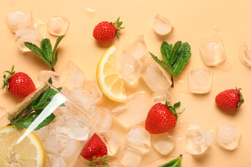 Glass with ice cubes, lemon, fresh strawberries and mint leaves on orange background