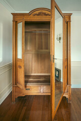 Vintage wooden wardrobe inside an empty room