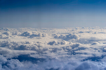 View of clouds in the sky from an airplane window