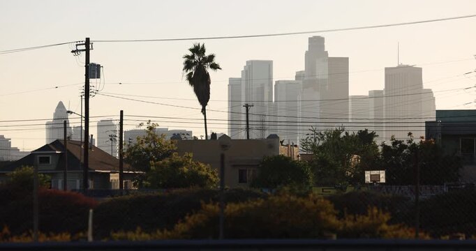 Power line framed afternoon view of historic homes in the Lincoln Heights neighborhood of Los Angeles, California, USA.