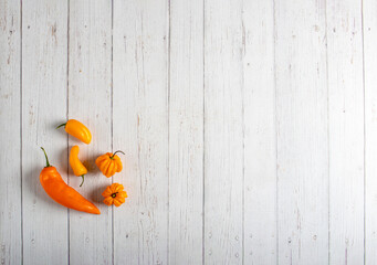 Minimalist Arrangement of Exotic Yellow and Orange Chili Peppers