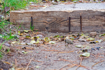 Wooden step board with rusty screws set in the grain