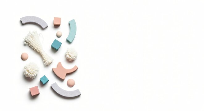 Playful Pastel Arrangement with Toys and Pom-poms on White Background