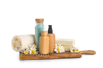 Bottles of cosmetic products and chamomile flowers isolated on white background, closeup