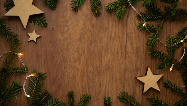Festive Christmas wreath with wooden stars and fairy lights on wood - Powered by Adobe