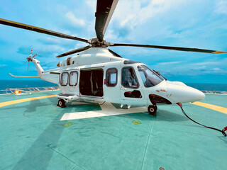 White Helicopter Parked on Offshore Oil Rig Helideck