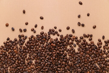 Scattered coffee beans on beige background