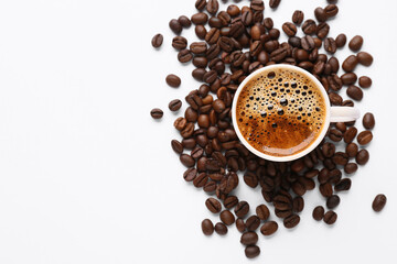 Coffee beans and cup of coffee on white background