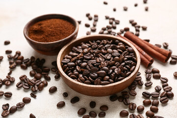 Cinnamon sticks with coffee beans and powder on light background