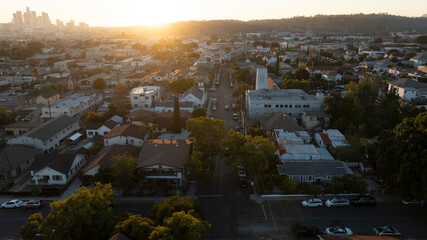 The sun sets on homes and a church in the historic Lincoln Heights neighborhood of Los Angeles,...