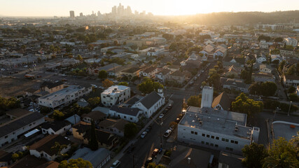The sun sets on homes and a church in the historic Lincoln Heights neighborhood of Los Angeles,...