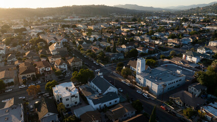 The sun sets on homes and a church in the historic Lincoln Heights neighborhood of Los Angeles,...