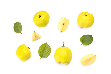 Fresh quinces with cut pieces and leaves on white background