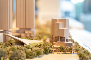 Wooden cityscape architectural model features buildings, waterfront, trees, urban planning concept