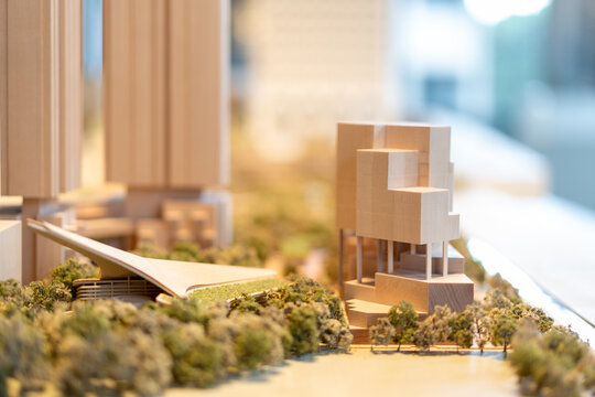 Wooden cityscape architectural model features buildings, waterfront, trees, urban planning concept