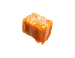 Tasty candy with salt and caramel sauce isolated on white