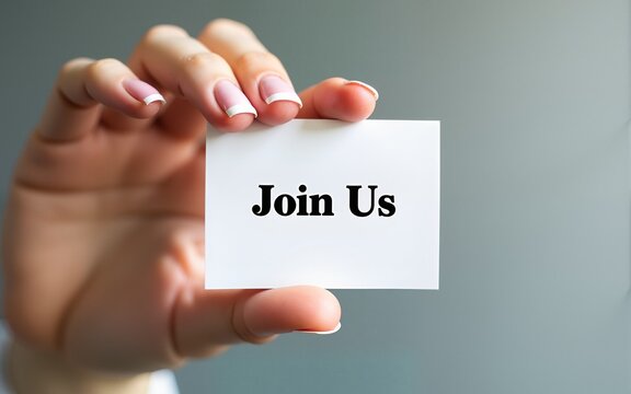 Hand holding a card with 'Join Us' message, emphasizing recruitment, teamwork, and inclusivity. Perfect for business and community outreach projects. High quality
