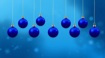 Row of blue christmas ornaments hanging against a blurred blue background