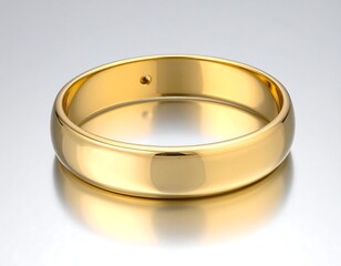 Gleaming gold band reflecting light on a smooth, gradient surface. A solitaire diamond sparkles