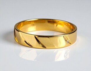 Gleaming, golden band with diagonal design and tiny diamonds, reflecting off a white surface