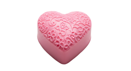 A single pink heart-shaped decorative item with a beautifully detailed and intricate embossed floral and filigree pattern is presented from a slightly elevated perspective