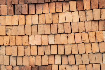 Fototapeta premium Stacked bricks forming construction material background pattern