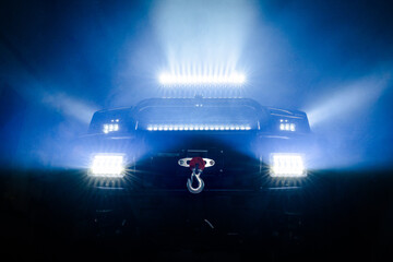 Off-road truck with LED light bars and winch in dramatic lighting