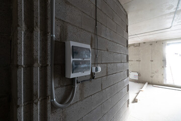Electrical breaker panel on block wall during rough in renovation