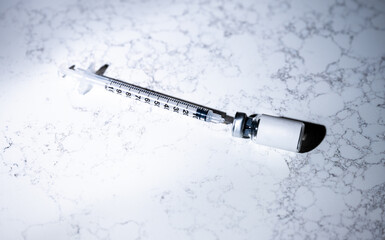 Close up of Single Use Syringe with Small Glass Vial