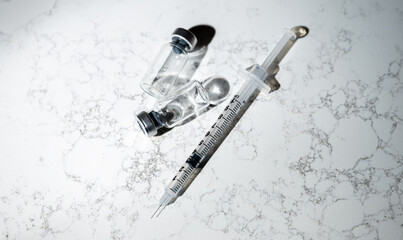 Close up of Single Use Syringe with Small Glass Vials