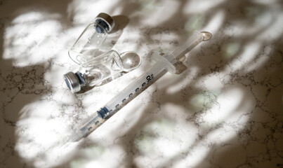 Close up of Single Use Syringe with Small Glass Vials