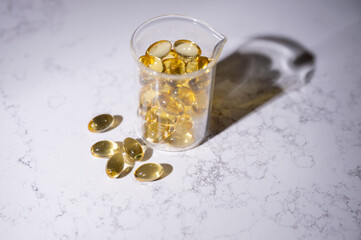 Close up of Semi Clear Fish Oil Capsules in Clear Glass Glass