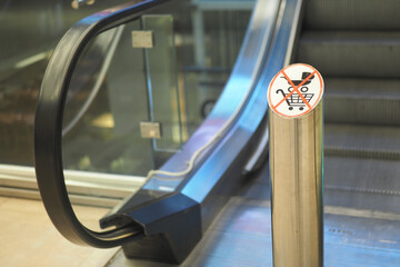 No shopping carts allowed on the escalator near the entrance