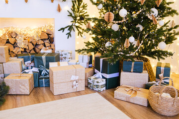Christmas tree decorated with white and beige ornaments in cozy home interior. Holiday season celebration with festive gift box.
