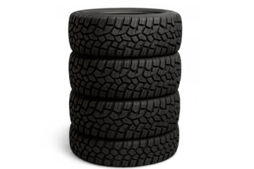 Stack of new black car tires with rugged tread pattern for off-road driving, isolated on a transparent background