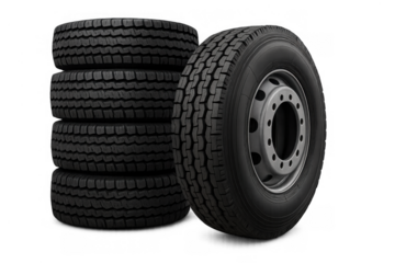 Stacked truck tires and one tire mounted on a wheel, new black rubber treads for heavy duty commercial vehicles