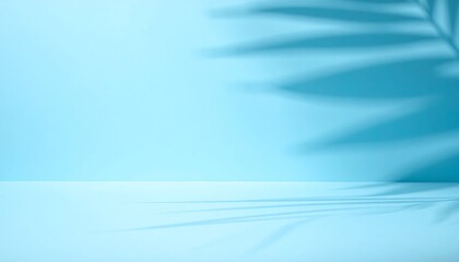Soft blurred palm shadows fall across a pastel blue wall, forming a clean minimal backdrop ideal for bright seasonal product presentations.