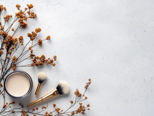 A makeup brush and foundation are arranged with dried flowers on a textured white background, creating a natural and elegant composition.