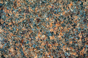 High-resolution close-up of a multicolor granite stone surface with speckled mineral patterns. Detailed natural texture ideal for backgrounds, 3D materials, architectural design, and product mockups.