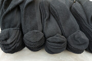 Stacks of clean black socks ready for use in a cozy home setting with soft texture and neat presentation