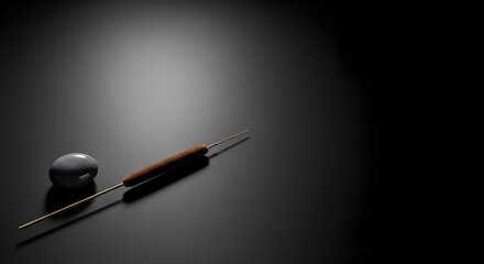 Elegant Still Life Featuring a Textured Sphere and Whisk on Dark Surface