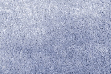 Soft blue carpet texture creates a calming atmosphere in a cozy room, inviting relaxation and comfort