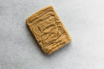 Brown sugar fudge slab on a marble tray, caramel fudge candy on a marble tray