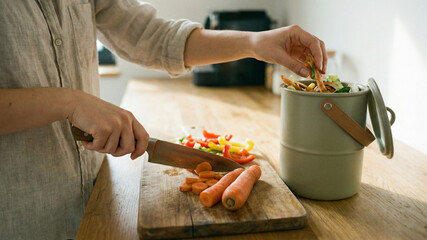 Woman Composting Vegetable Scraps While Preparing a Healthy Meal in a Sustainable Kitchen