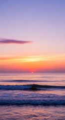 Fototapeta premium Ocean sunset serene scene colorful sky orange light horizon waves