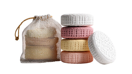 Stack of colorful cosmetic solid shampoo bars with a mesh bag isolated on transparent background