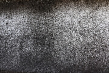 The wall is a rough white surface with black stains on it. Ideas for textured images, chalkboards, free space for text. and decorative patterns	
